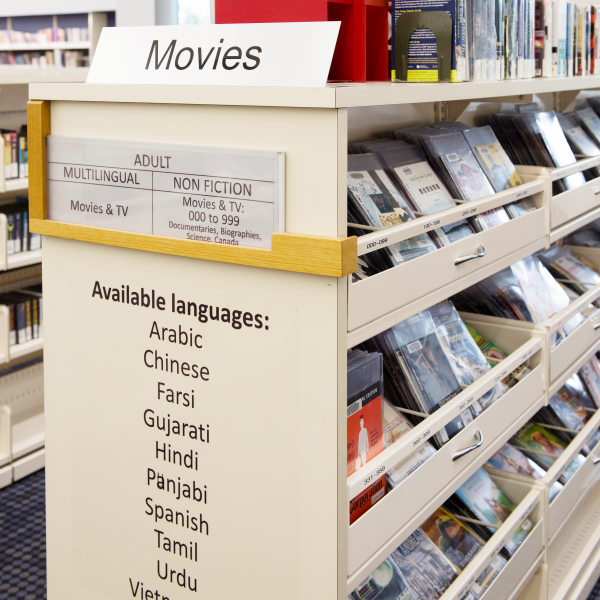Multilingual movies on a shelf at the Main Branch