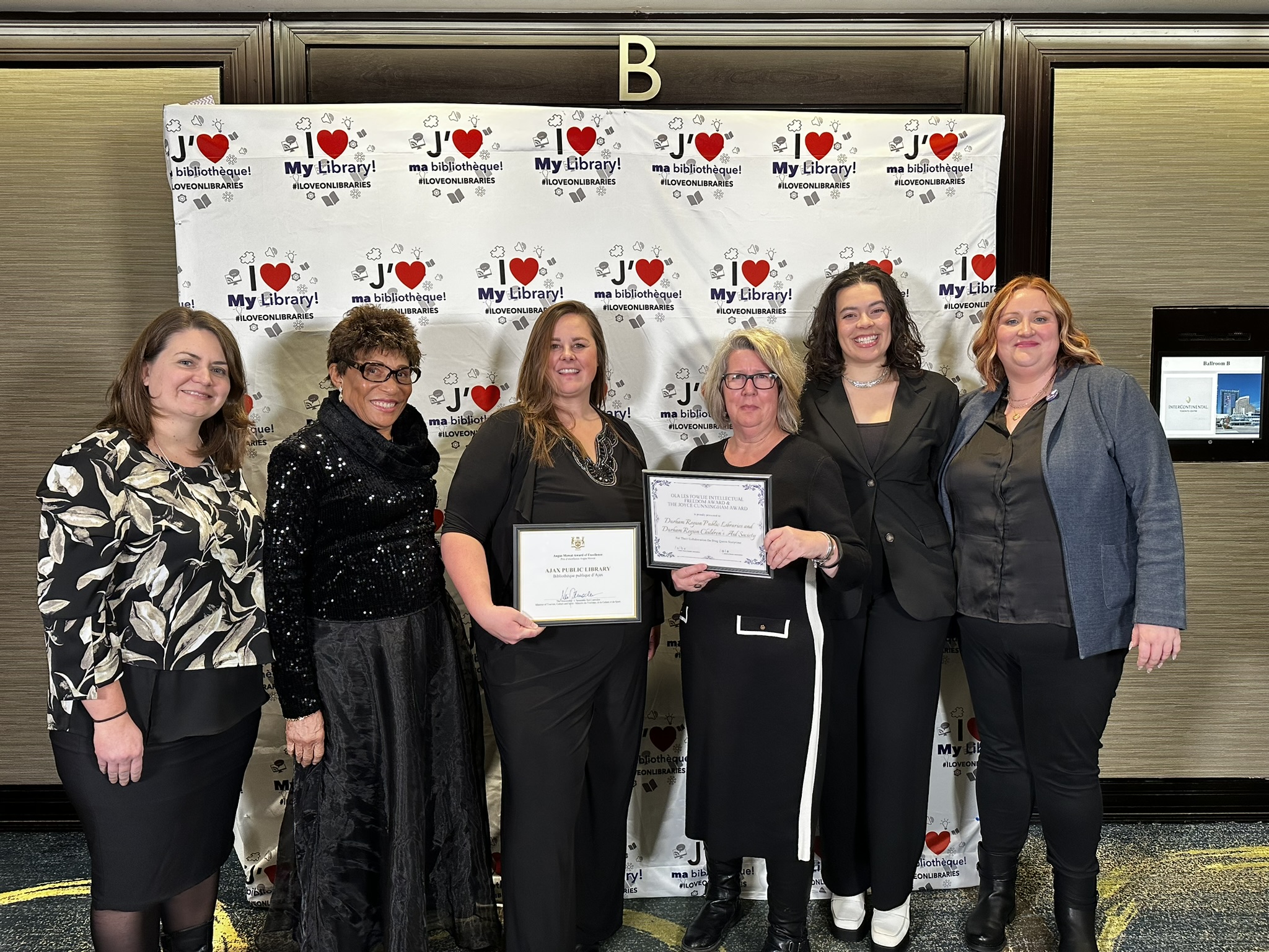 Library staff and board member holding their two awards at the OLA Super Conference gala on January 25, 2024.